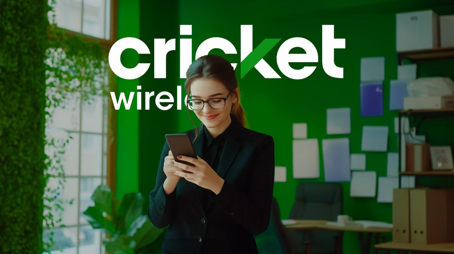 A person holding a smartphone with Cricket Wireless logo on the screen