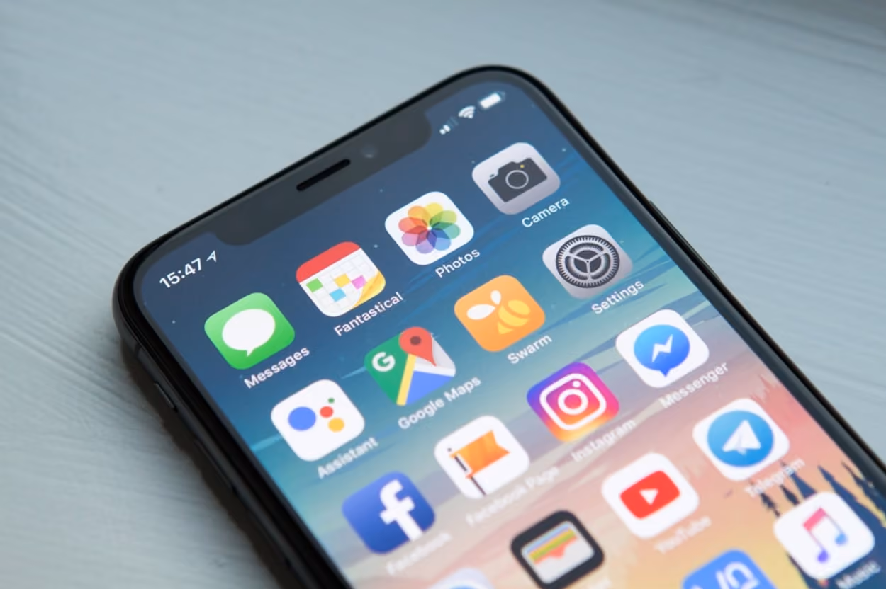 An iPhone displaying various social media applications on its screen, showcasing modern digital connectivity.
