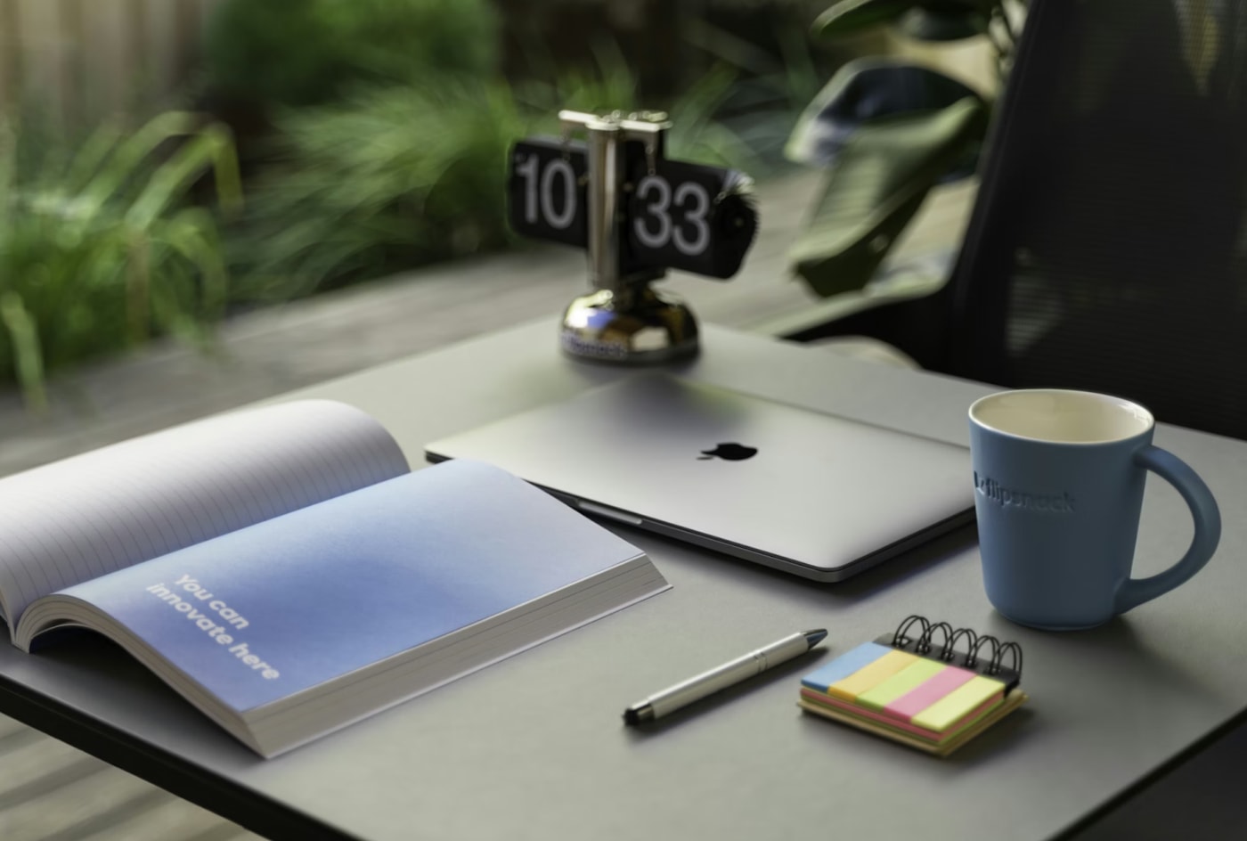 A notebook and a coffee mug placed on a wooden desk, creating a cozy workspace atmosphere.