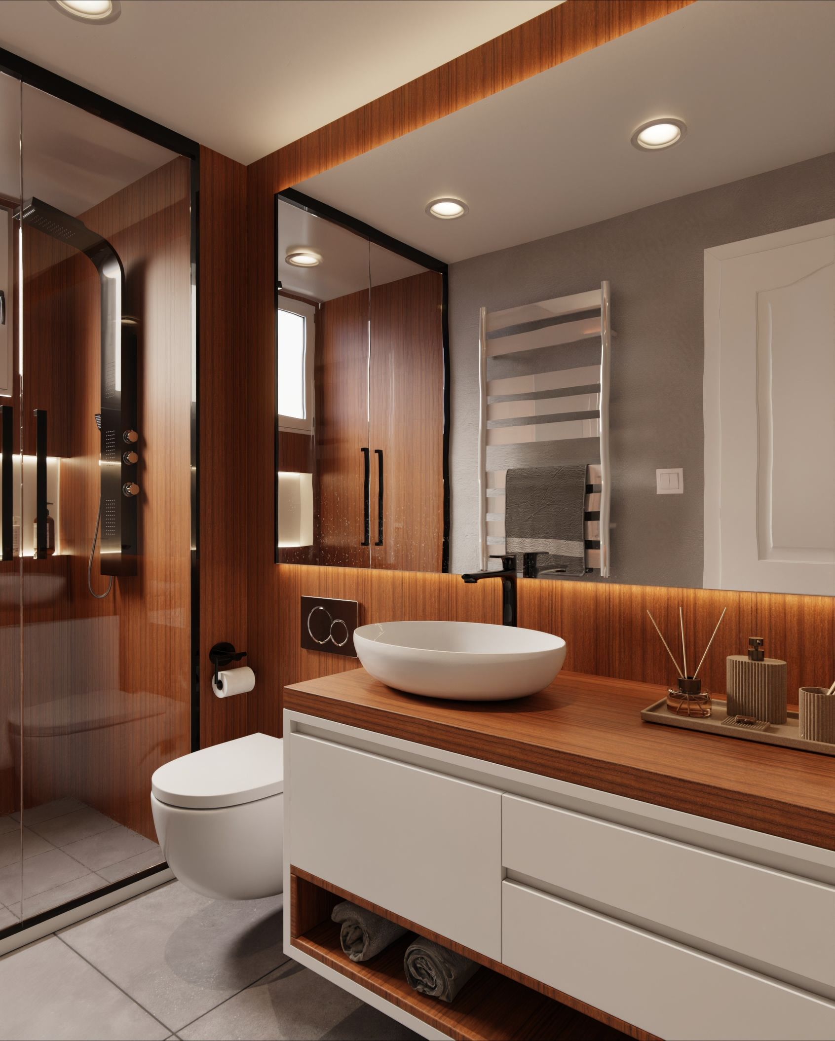 Salle de bain moderne avec un lavabo rond blanc sur un plan de travail en bois, toilettes suspendues, cabine de douche vitrée et grand miroir rétroéclairé.