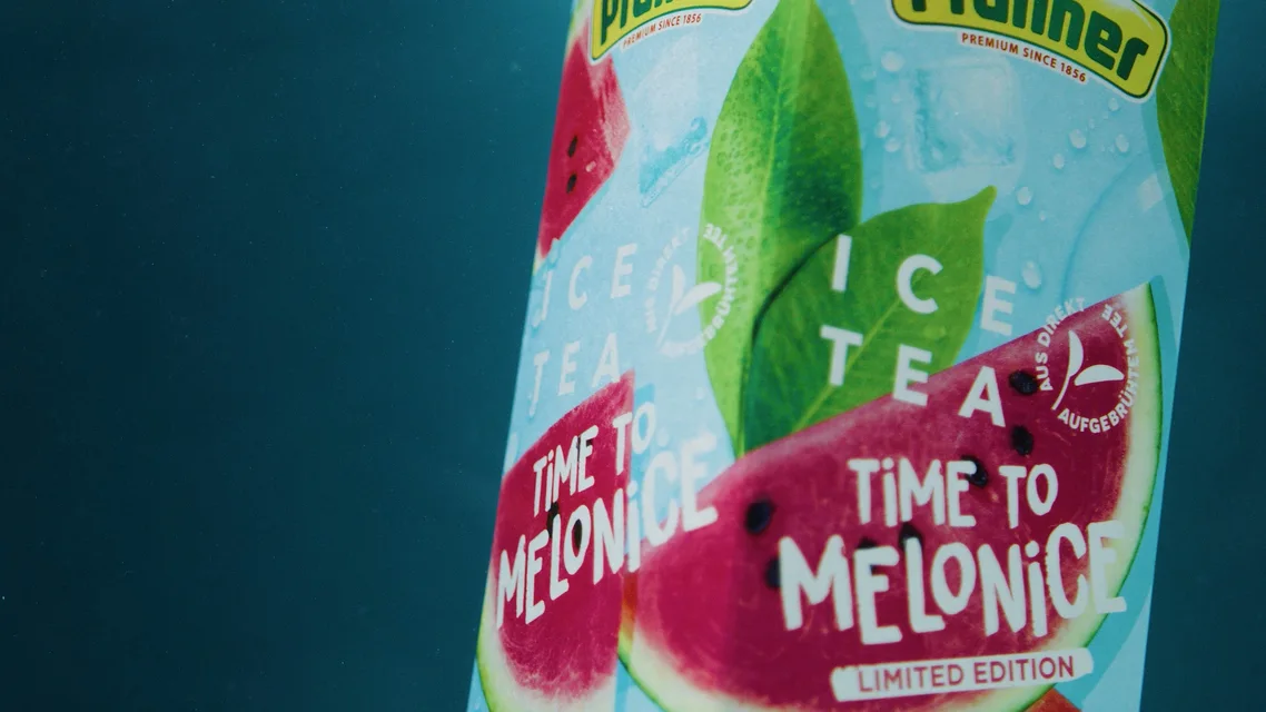 Close-up of a Pfanner ice tea bottle labeled 'Time to Melonice' with watermelon slices and green leaves graphic.