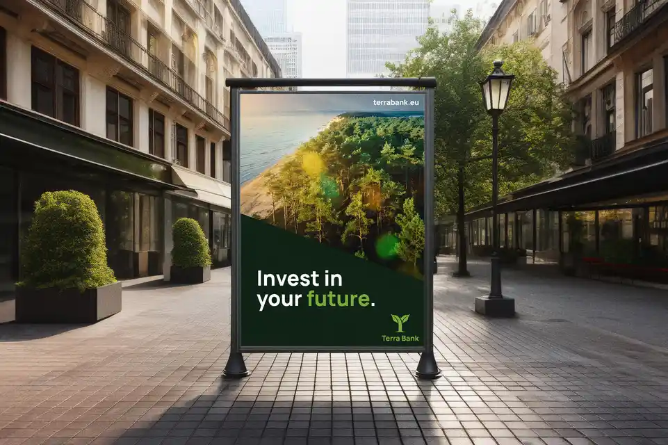 Outdoor advertisement board in a city street displaying a green forest scene with the text 'Invest in your future.' and Terra Bank logo.