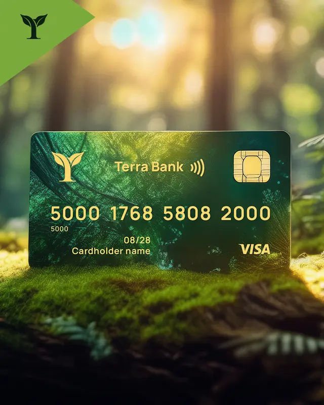Green Terra Bank Visa credit card with gold lettering and chip, placed on mossy forest ground with blurred light background.