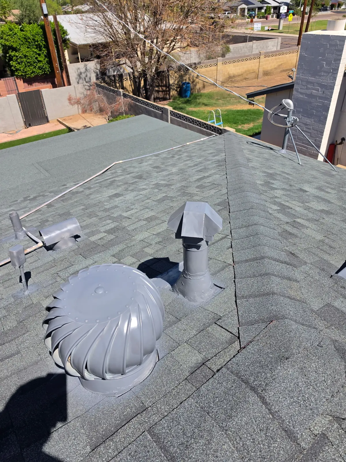 Roof ventilation and penetration details on completed Scottsdale shingle roof