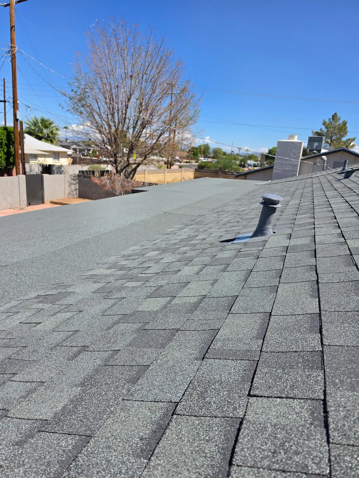 Transition between architectural shingles and low-slope roofing in Scottsdale
