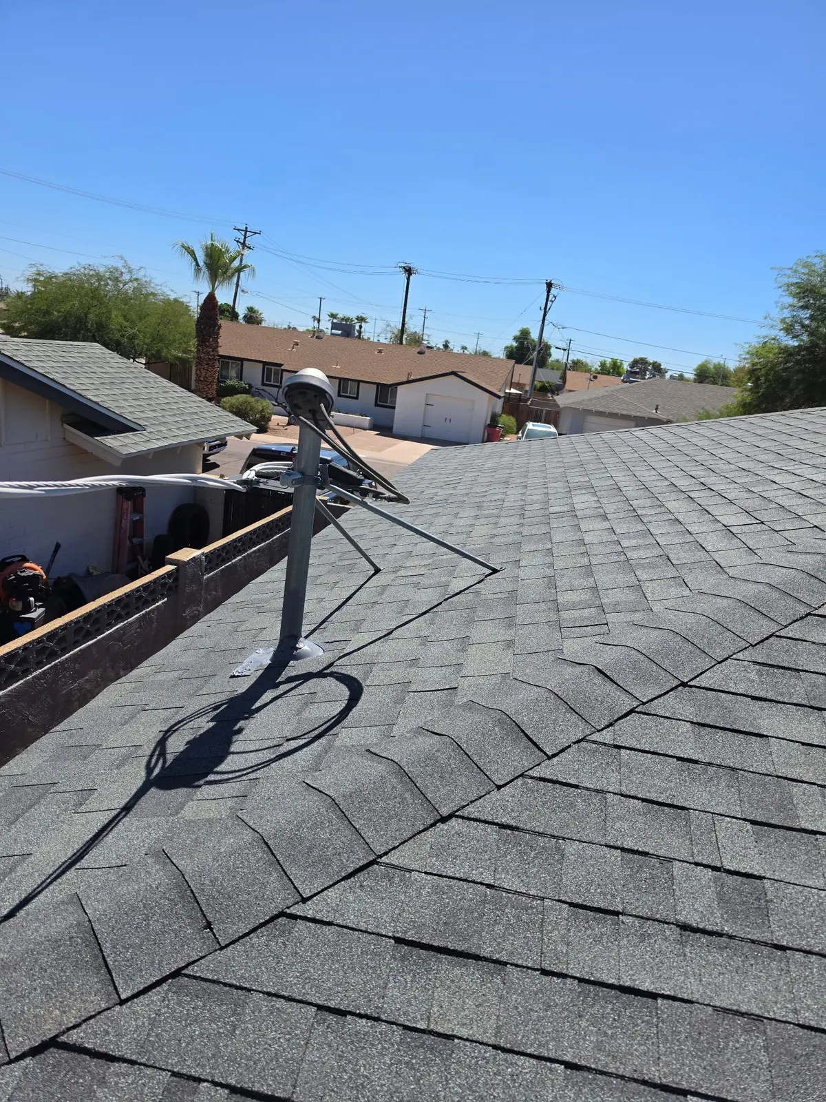 Finished shingle roofing around satellite mount in Scottsdale