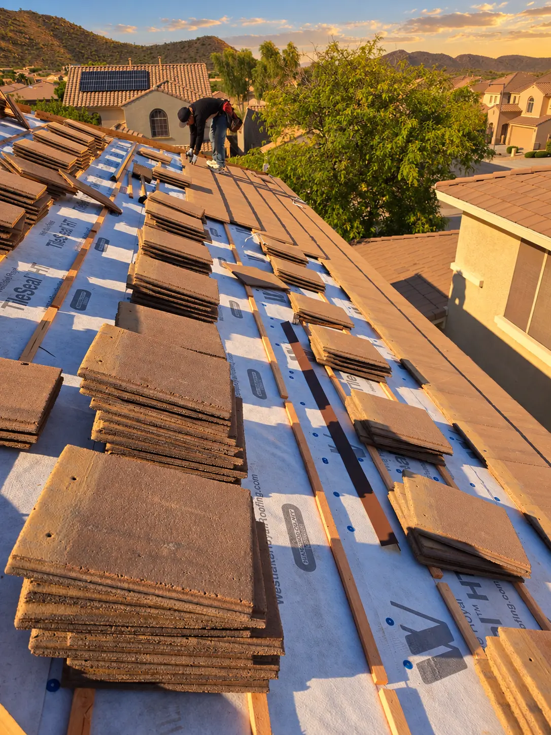 Concrete roof tiles staged during an underlayment replacement in Phoenix