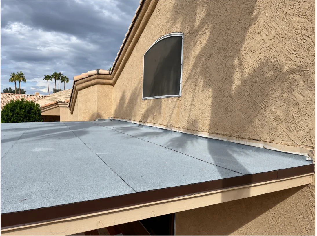 Low-slope roof surface adjoining a stucco wall at the Chandler roofing project