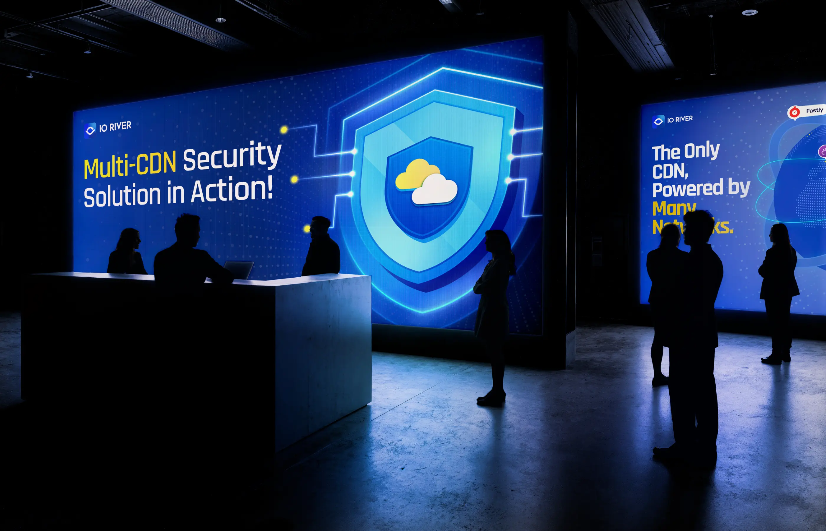 People silhouettes in a dark room with large illuminated screens about Multi-CDN security and network power.
