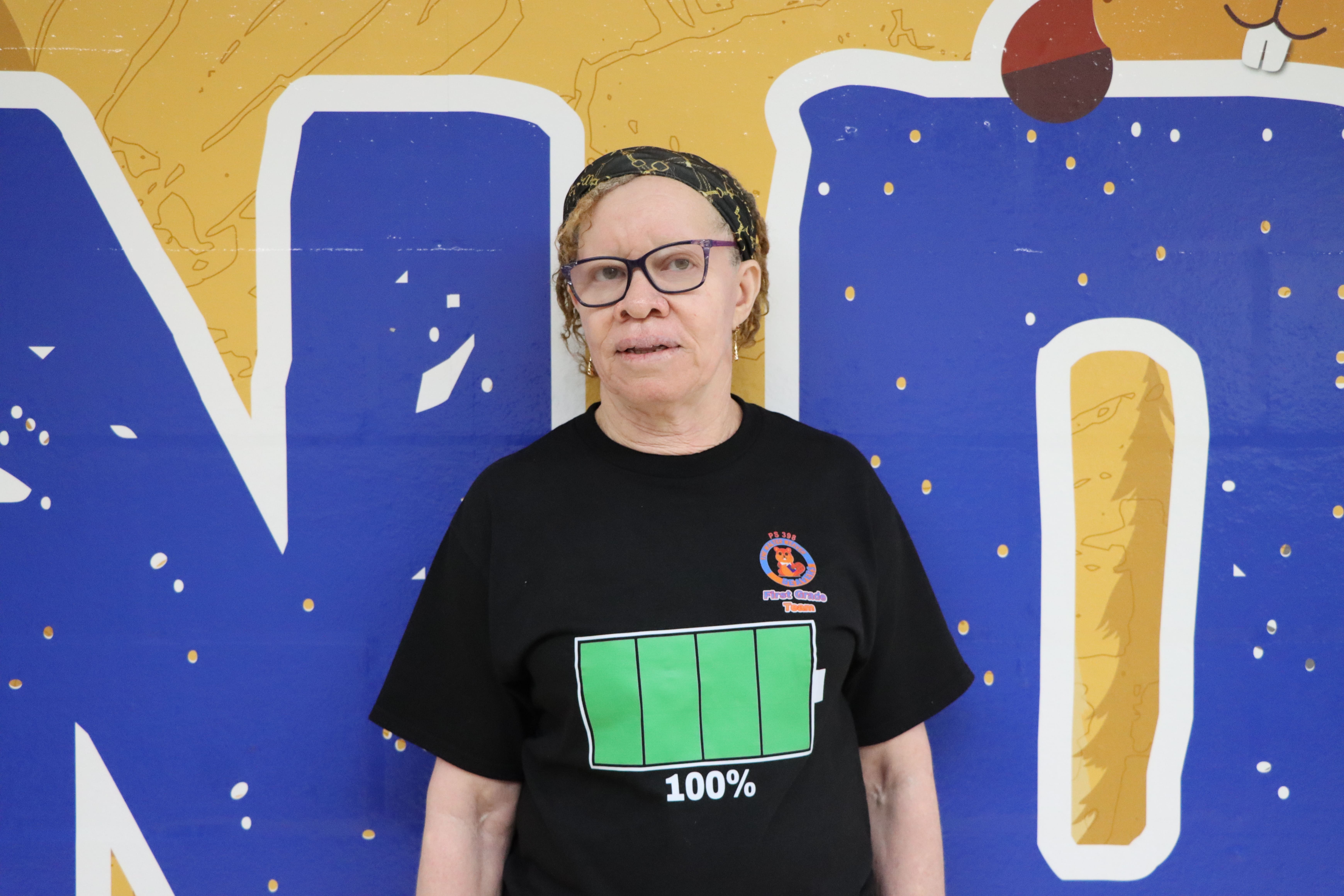 Staff member wearing black shirt with battery graphic
