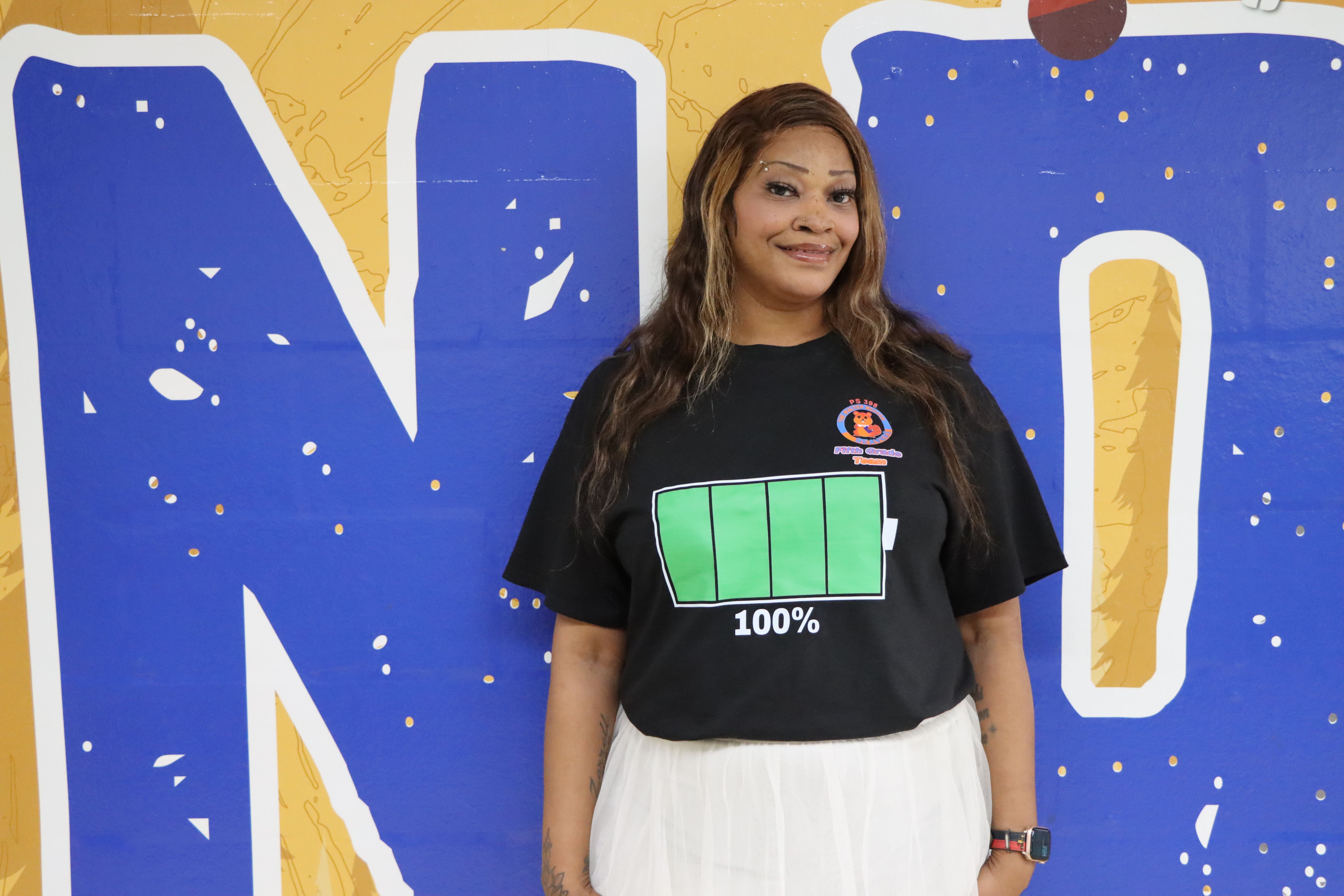 Staff member wearing shirt with charged battery graphic
