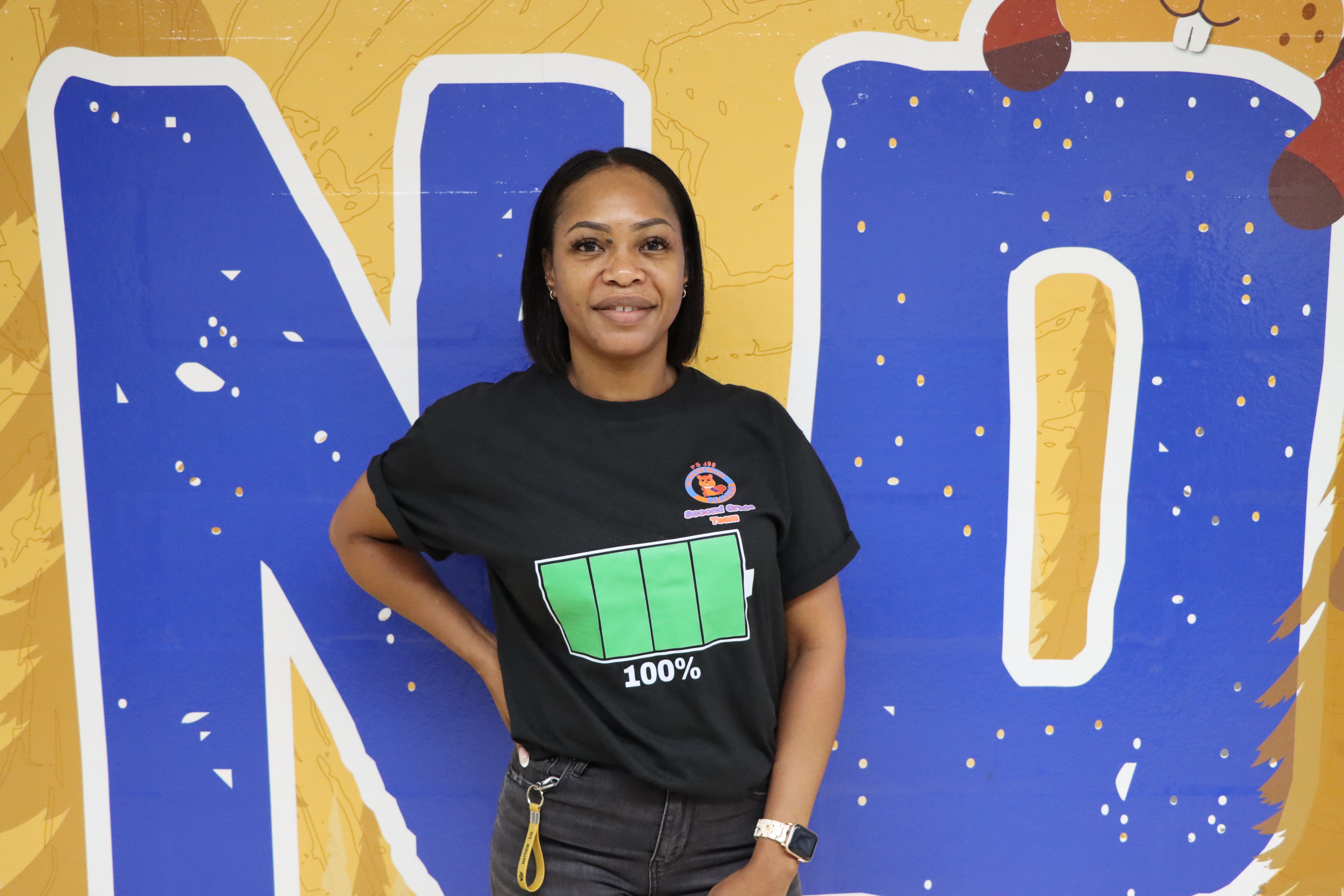 Staff member wearing black t-shirt with battery graphic