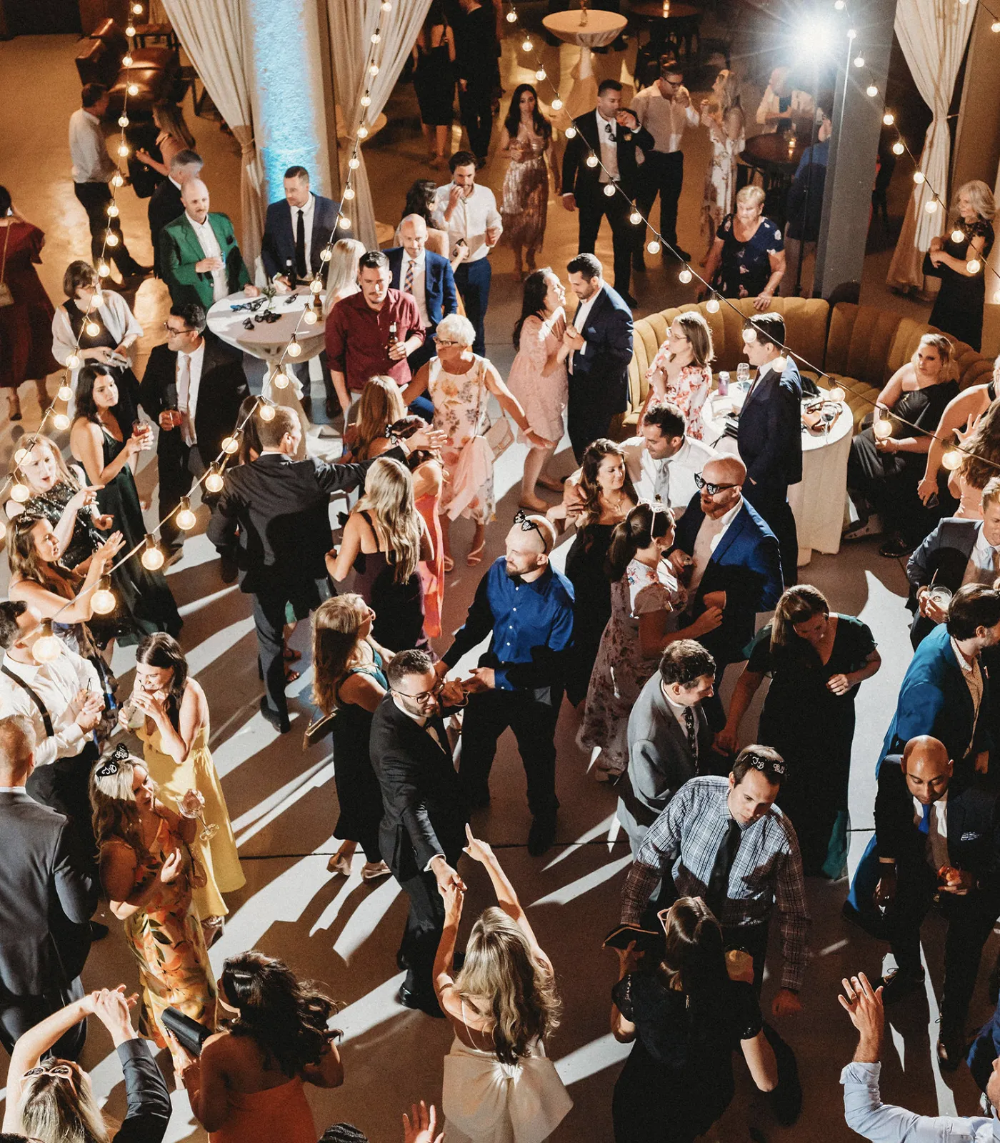 An aerial shot of a packed wedding reception dance floor.