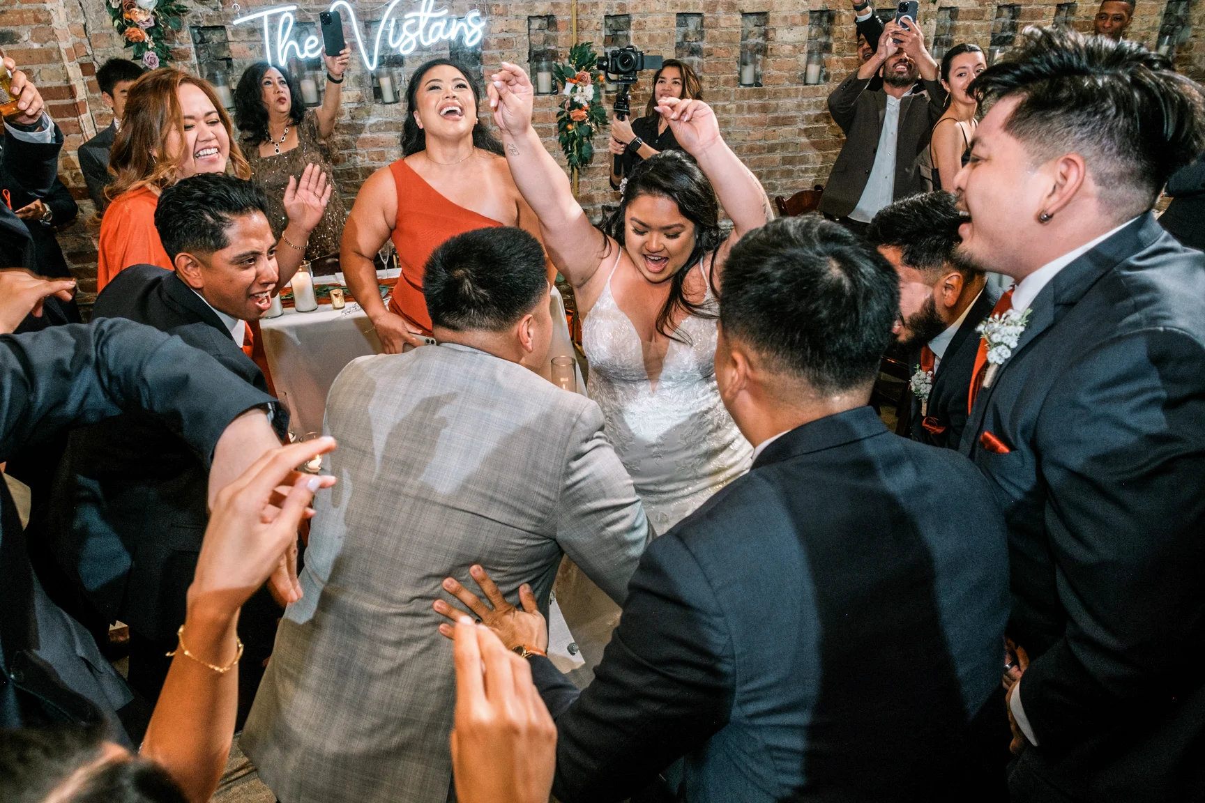 A couple dancing with their wedding party.