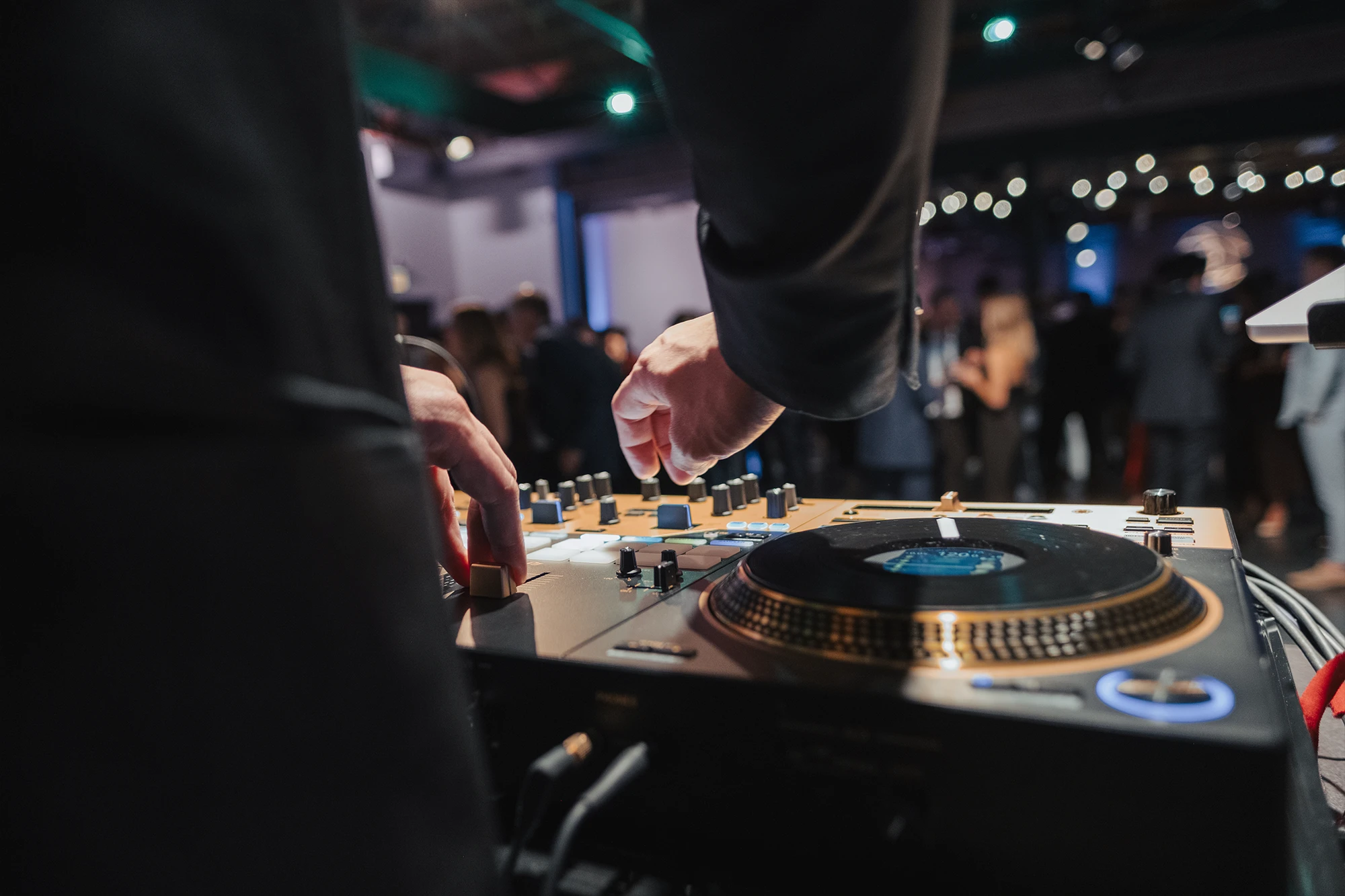 A DJ playing music on vinyl turntables.