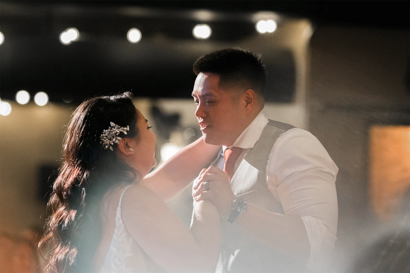 A bride and groom dancing together at their wedding reception.