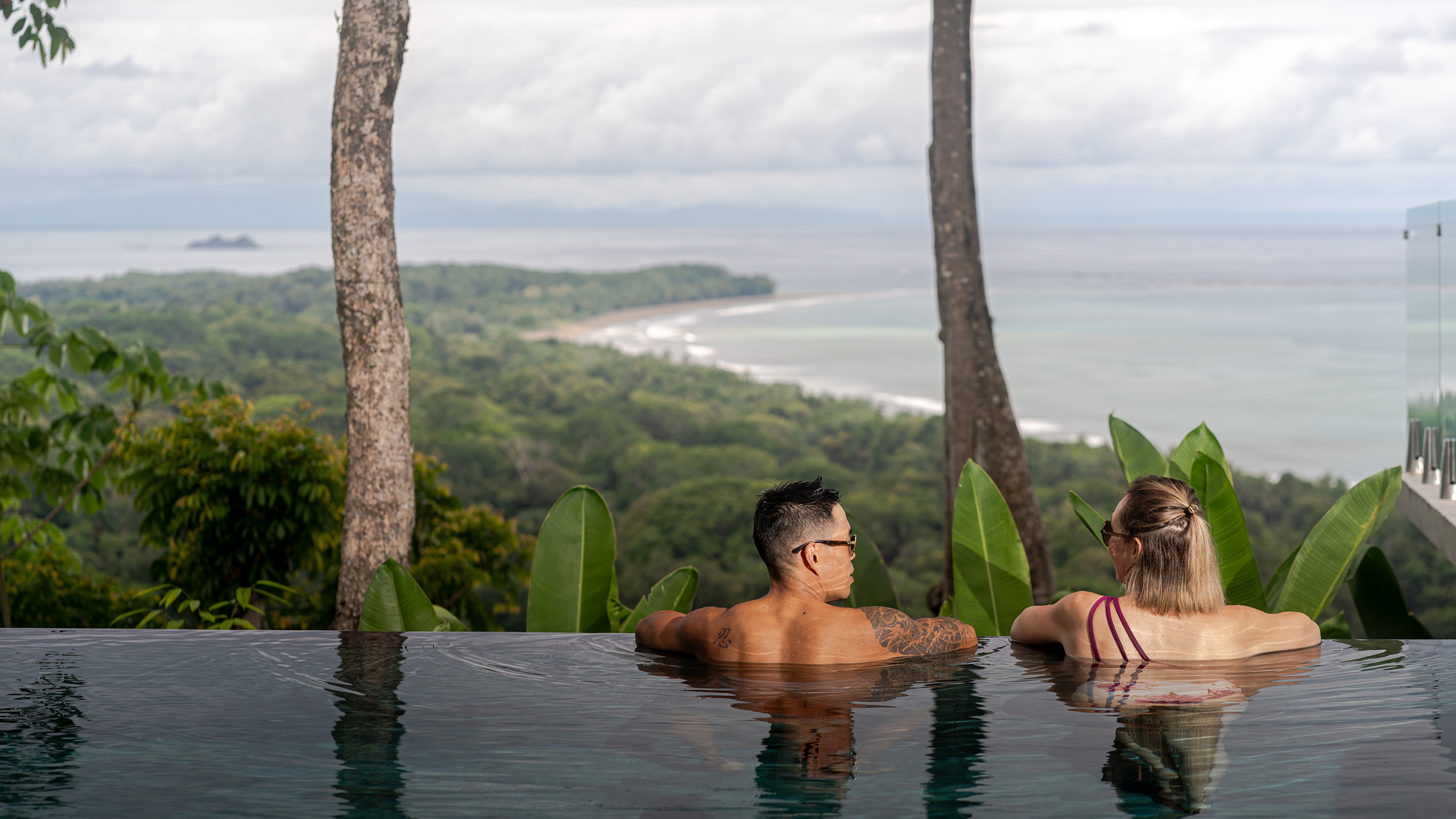 A couple with a breathtaking romantic view from the infinity pool at Casa LaVista