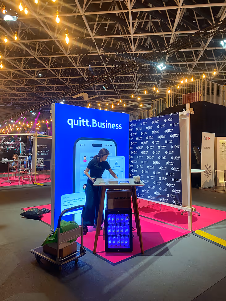 Person setting up a quitt.Business booth