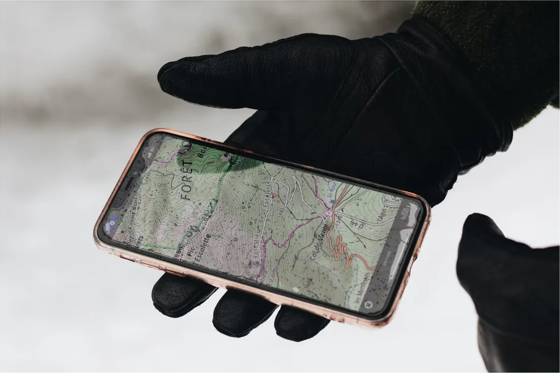 AI agent on phone showing map. Digital map navigation with smartphone. Hiking with AI.