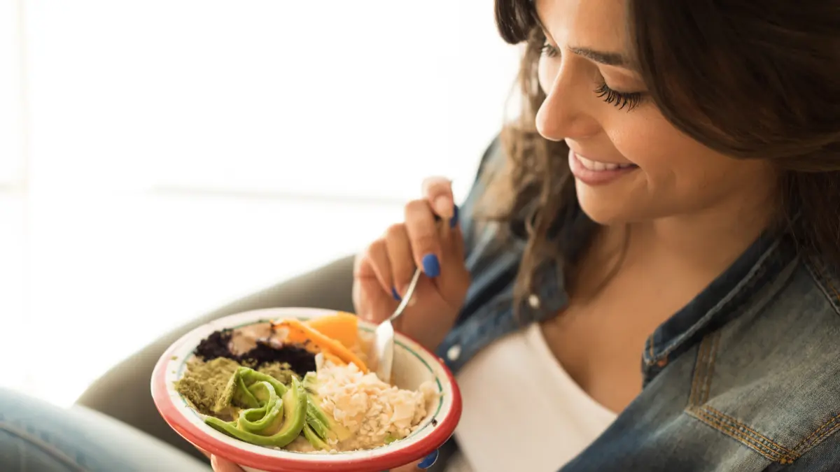 žena u svome domu jede recept s bliss-fit jelovnika za mršavljenje