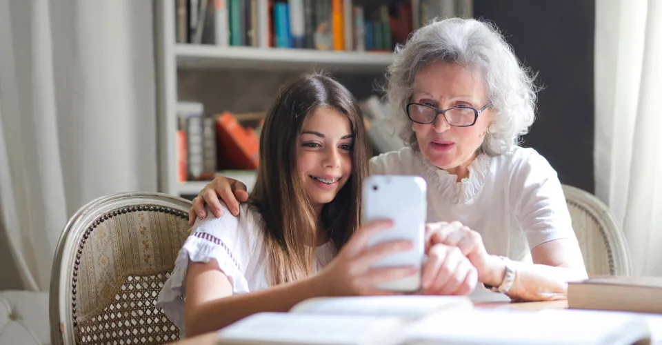 grandmother and girl using phone
