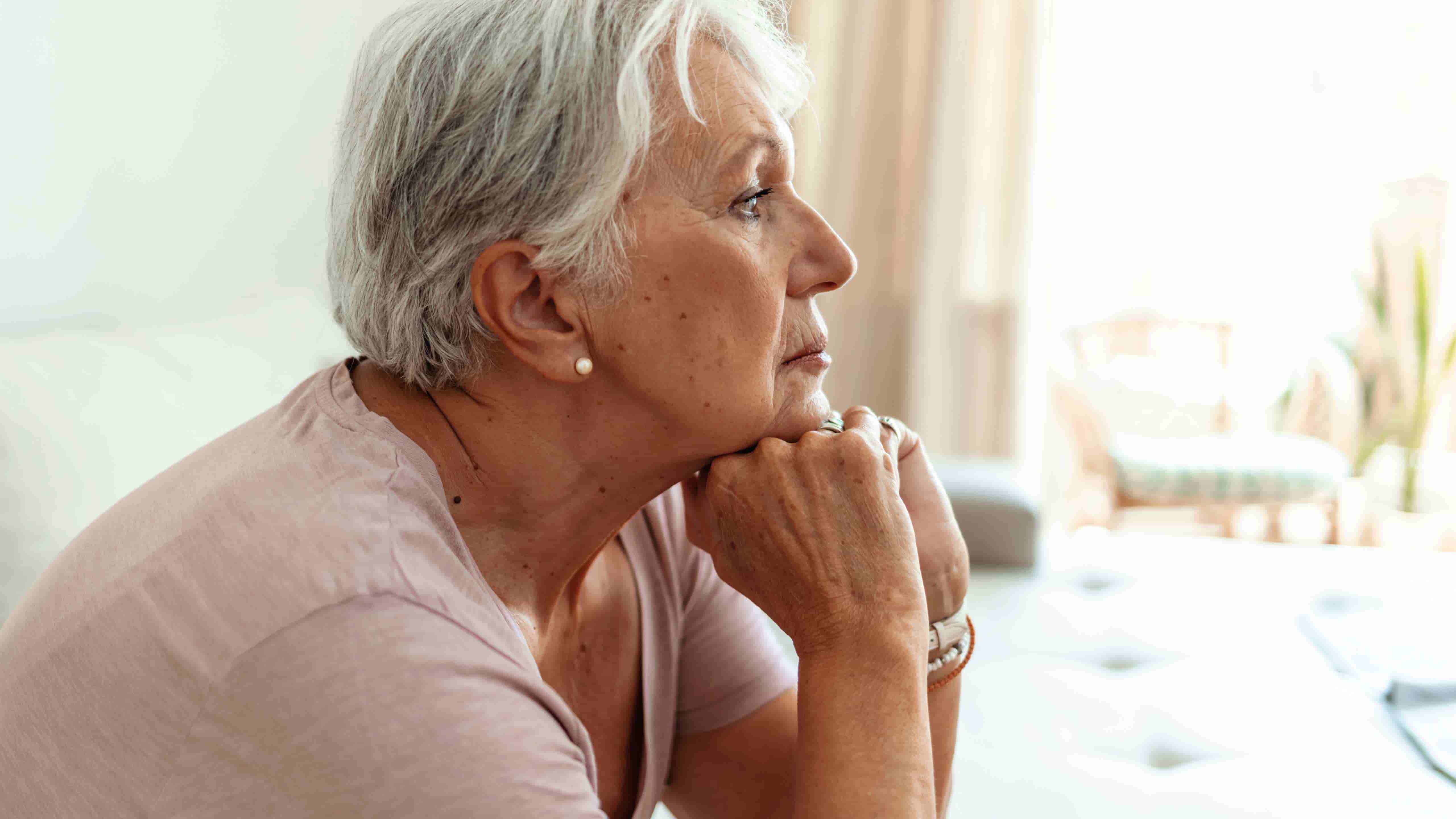 Old women looking thoughtfully out the window