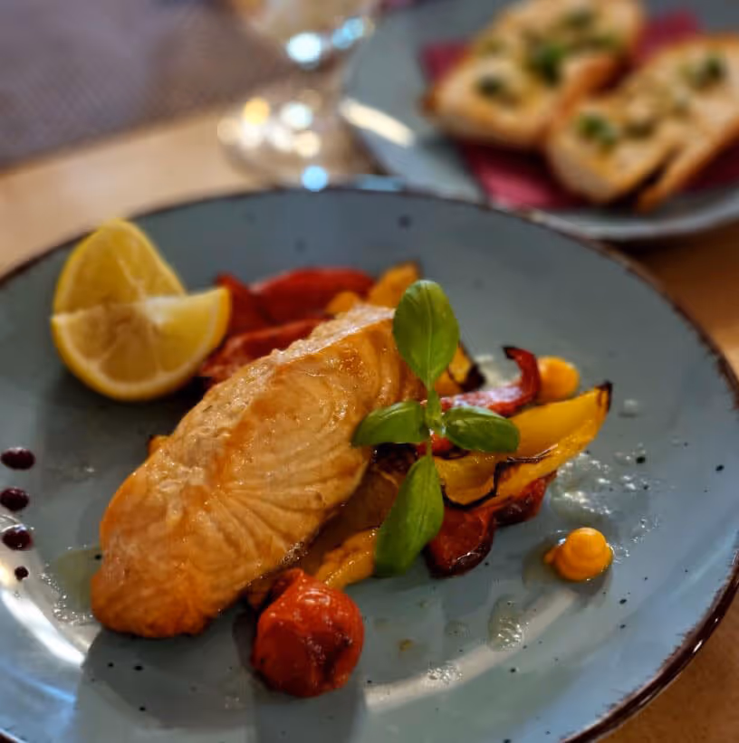 Plate of salmon with roasted vegetables served at a Czech restaurant after the Narnia & Bastei tour.