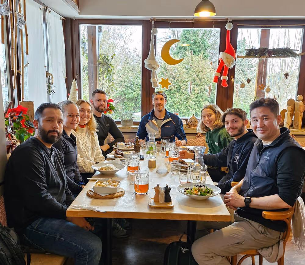 Tour group enjoying a traditional Czech lunch together at a cozy local Czech restaurant after the Narnia & Bastei winter tour.