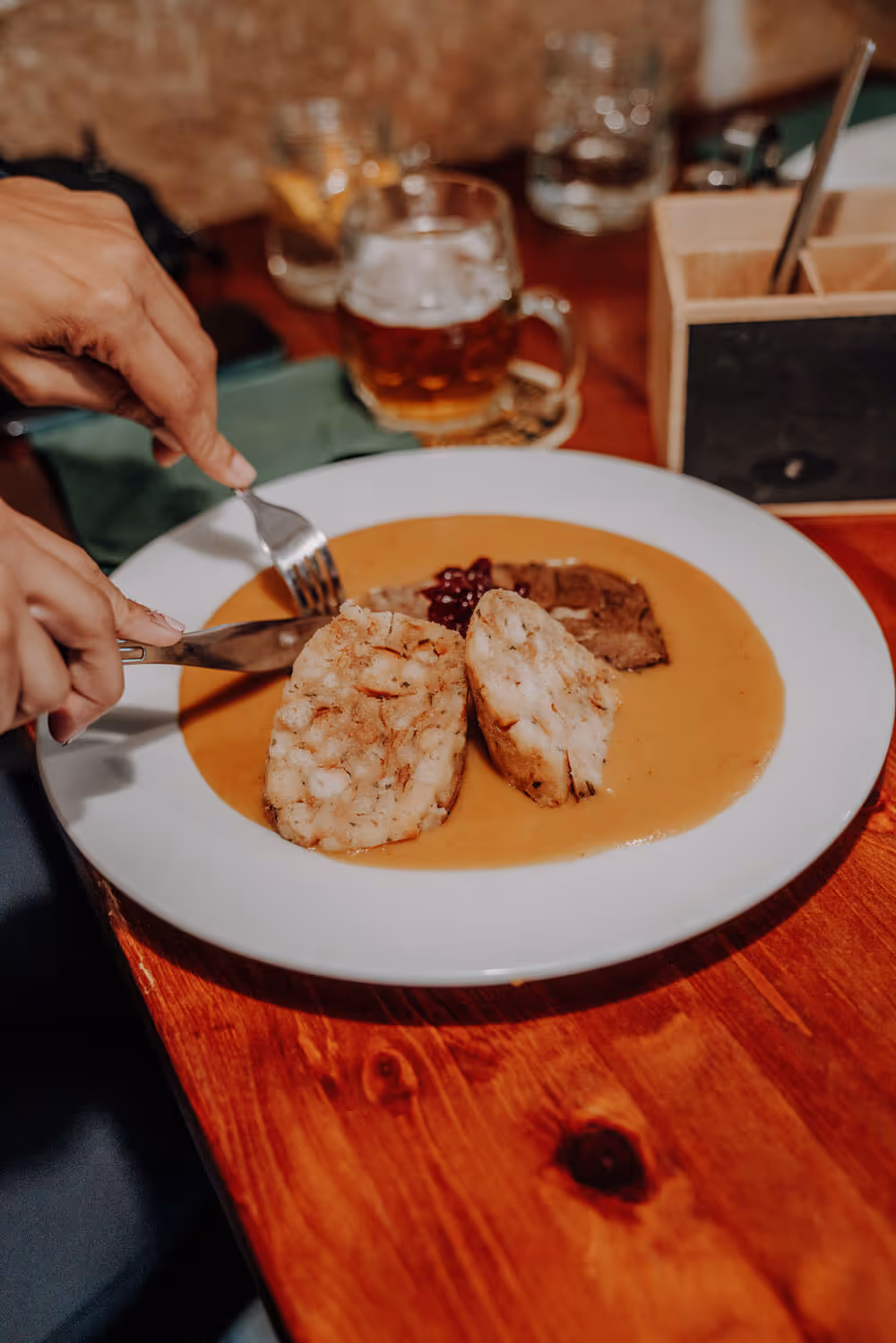 Traditional Czech dish with dumplings, sauce, and beef served with beer after the Narnia & Bastei hike.