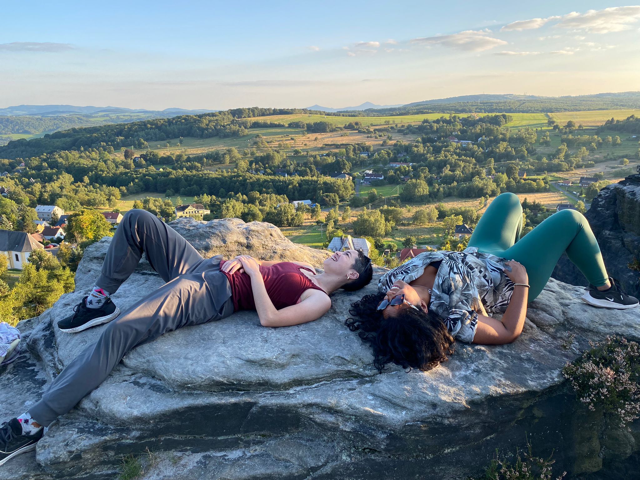 Hikers relaxing on the rocks with a countryside view