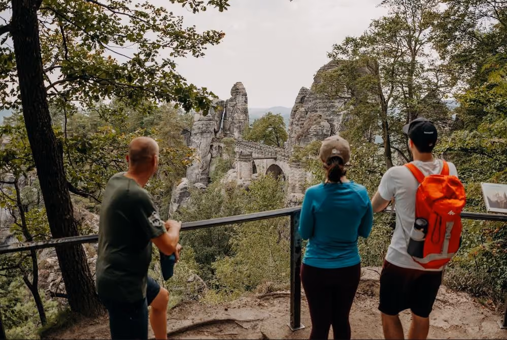 Visitors admiring the Bastei Bridge from a scenic viewpoint
