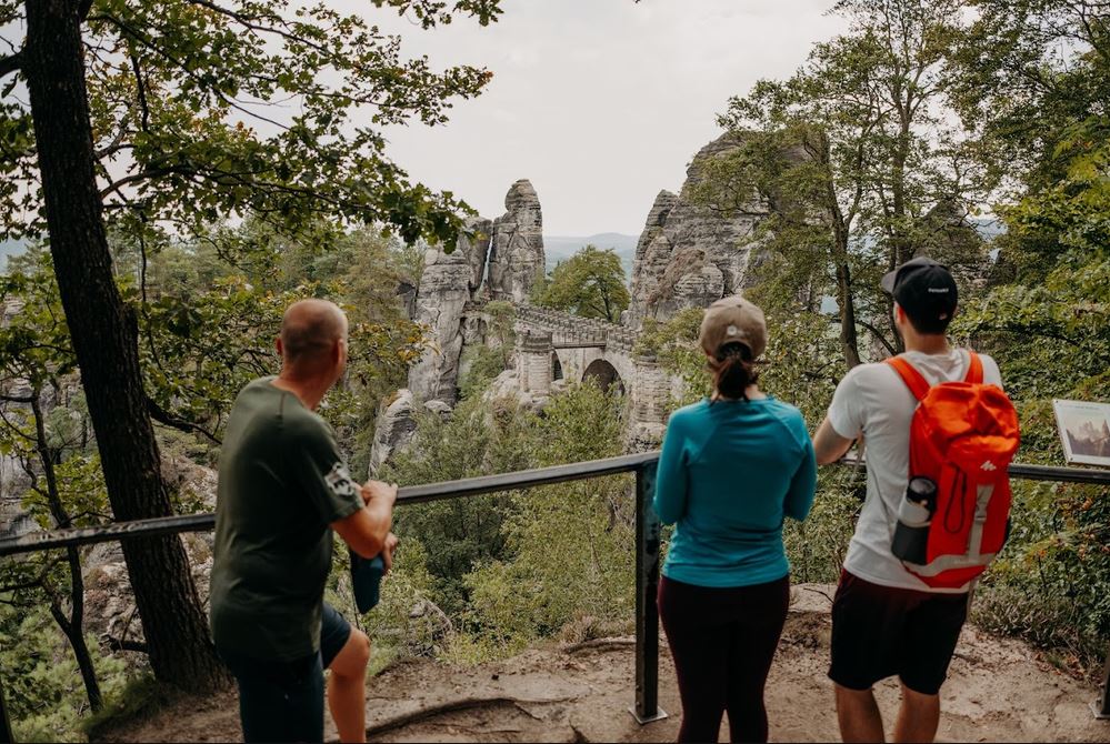 Visitors admiring the Bastei Bridge from a scenic viewpoint