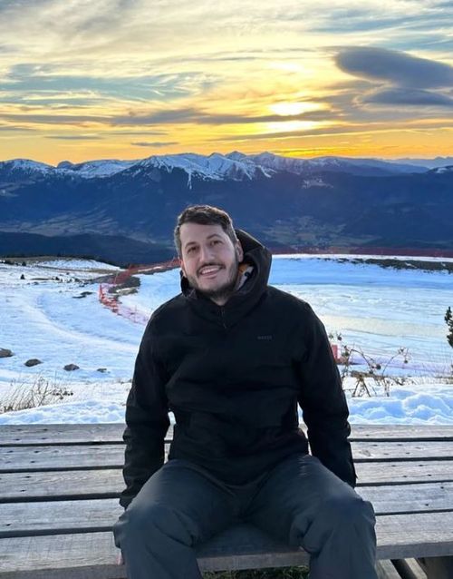 Picture of me in the alps, with a lot of snow in the background.