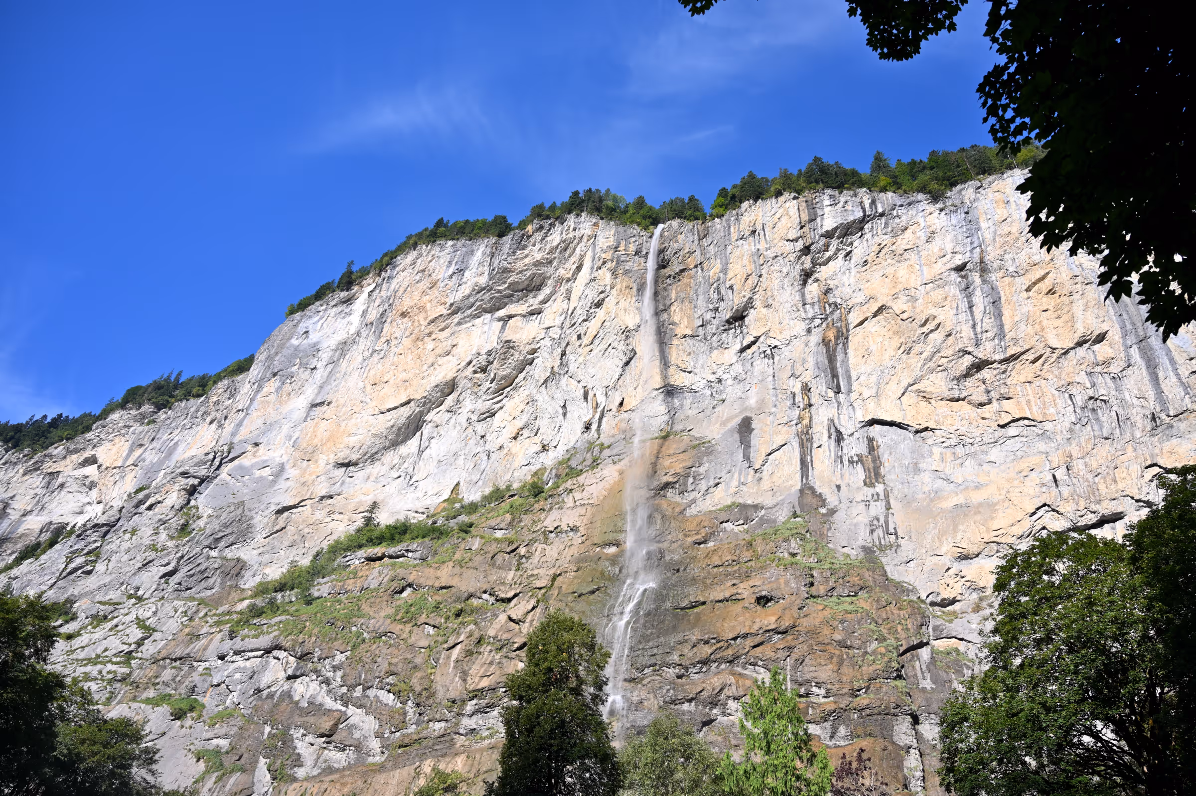 Steep limestone cliffs rising above Lauterbrunnen Valley in Switzerland.
