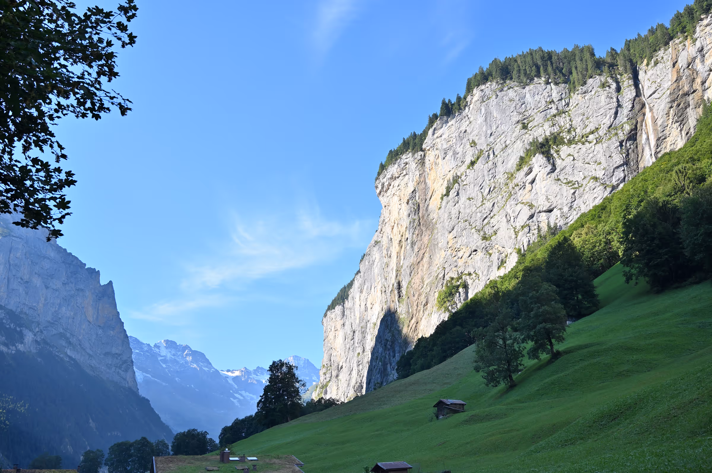 Sheer limestone cliffs rising vertically above the Lauterbrunnen Valley in Switzerland.