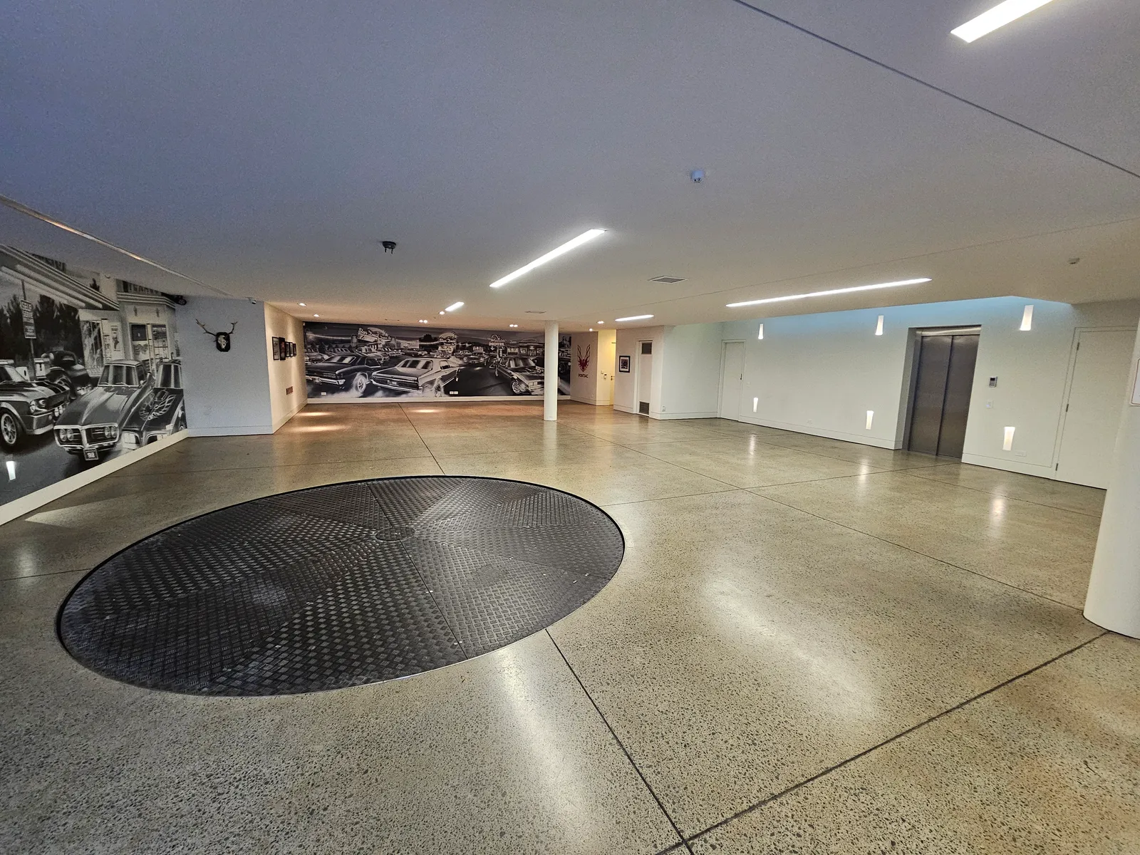 Matte polished concrete garage floor with car turntable in Mission Bay