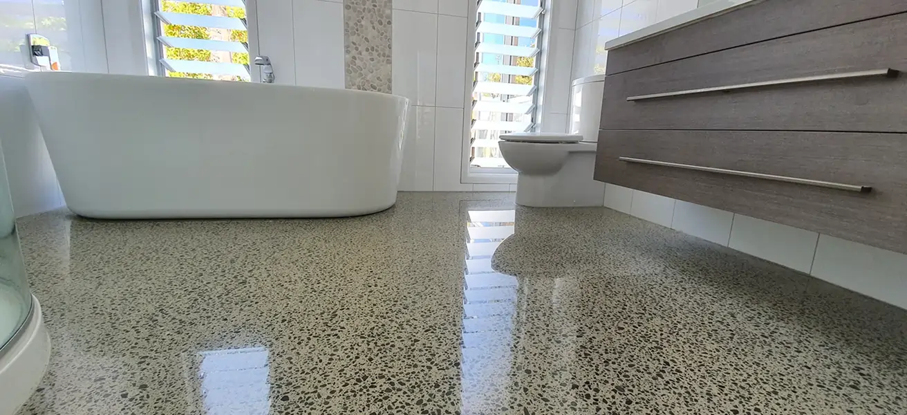 Diamond Shine Concrete high-gloss polished concrete kitchen floor with timber island in luxury Auckland home