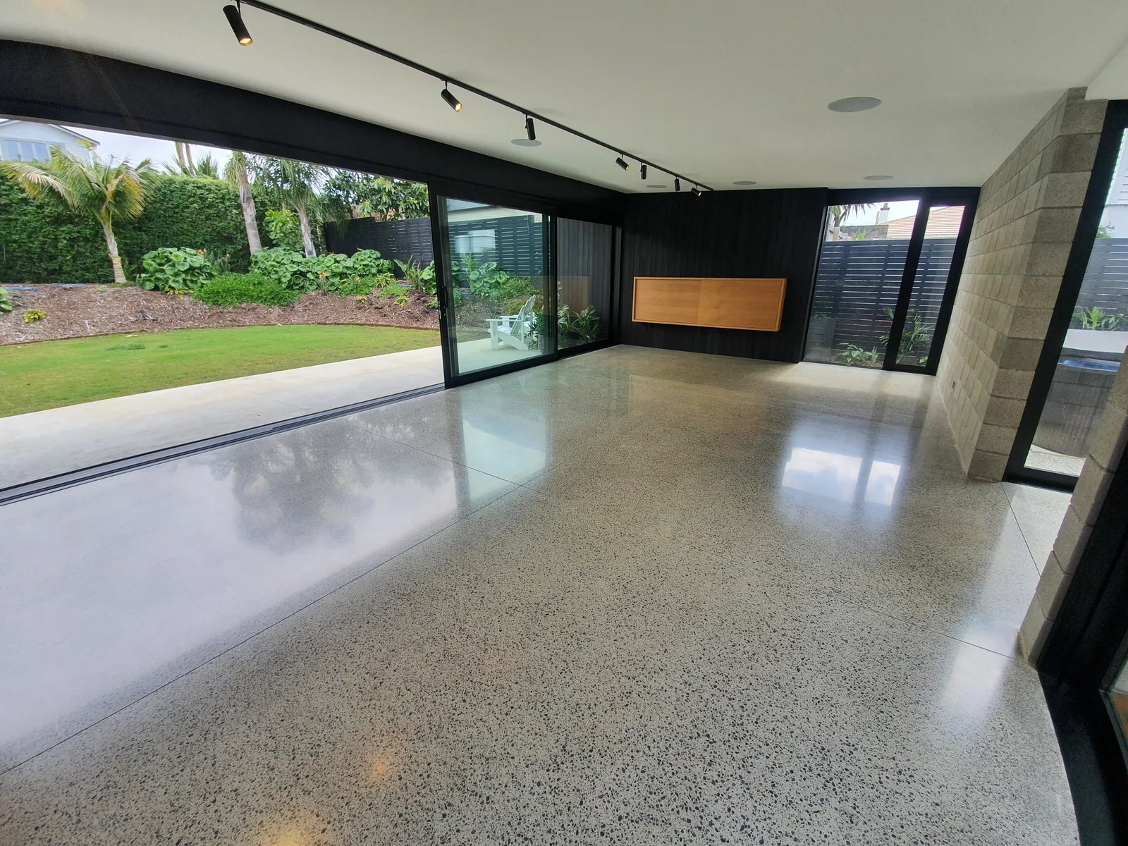 Diamond Shine Concrete polished concrete open-plan living floor with garden views in Auckland home refurbishment