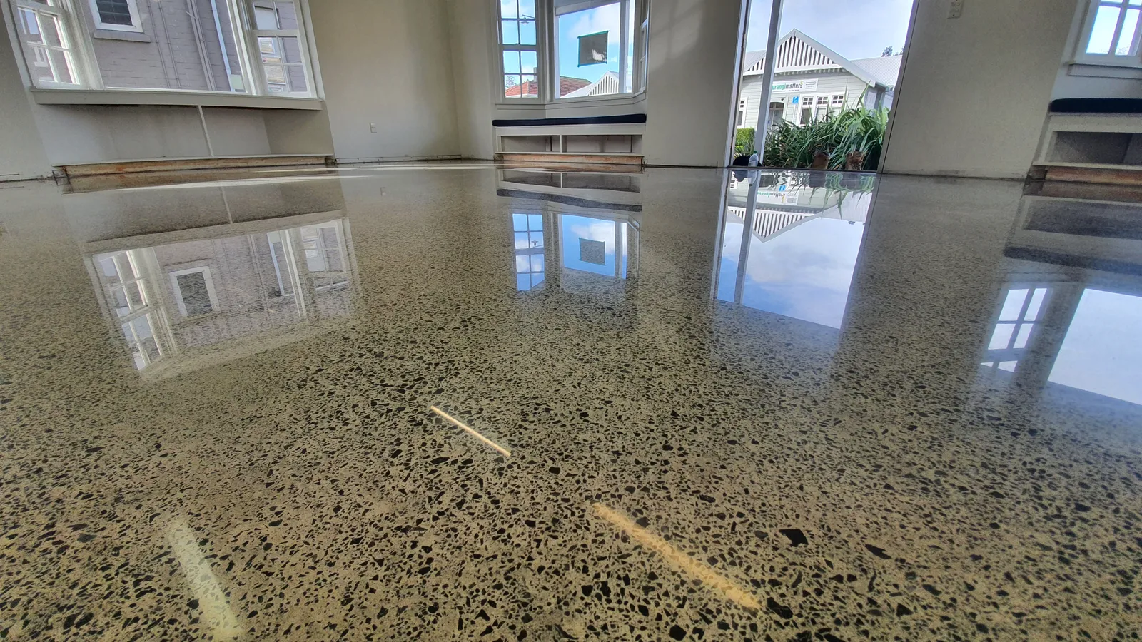 Diamond Shine Concrete close-up of mirror-finish polished concrete with exposed salt-and-pepper aggregate in Auckland commercial building