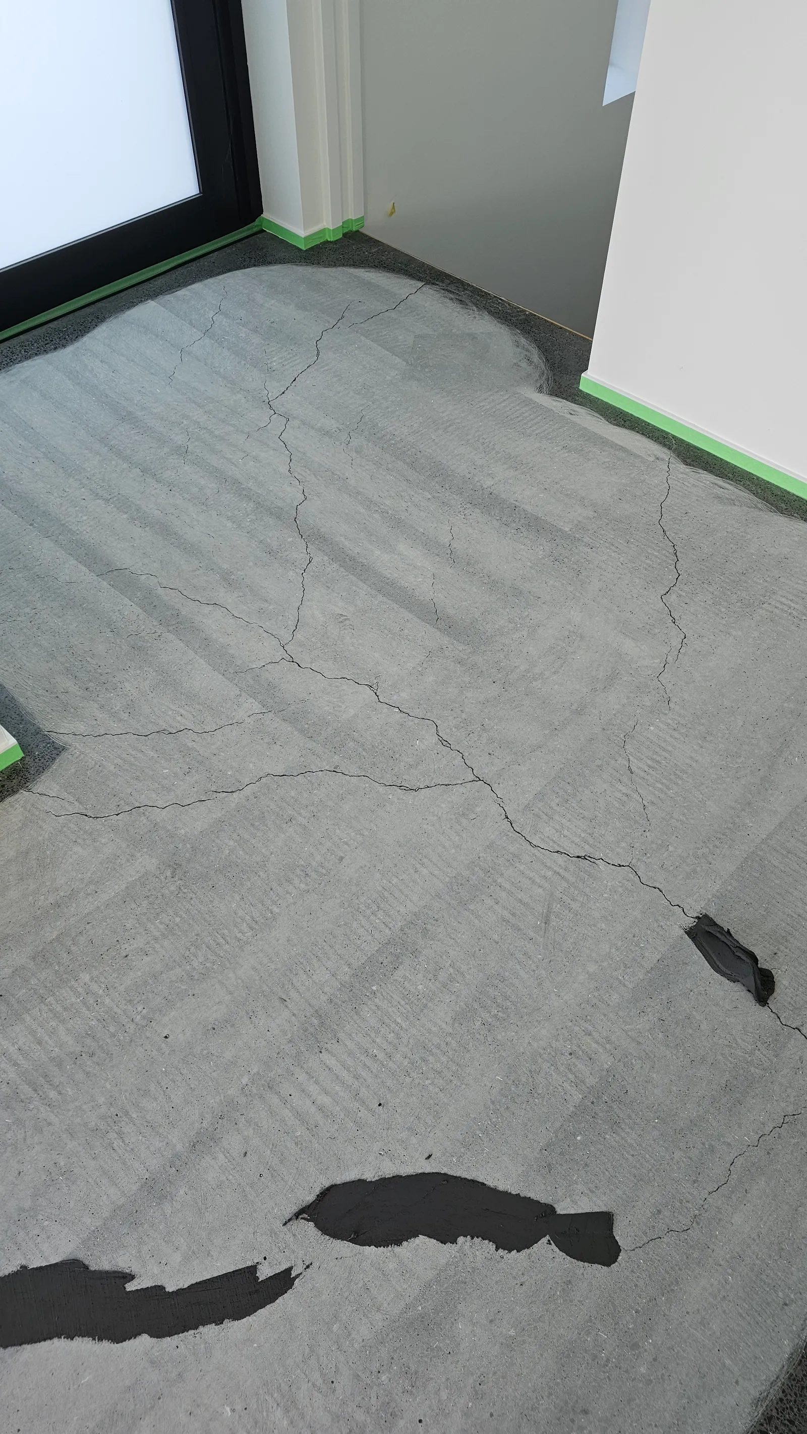 Diamond Shine Concrete before photo showing cracked and damaged concrete floor requiring repair in an Auckland home
