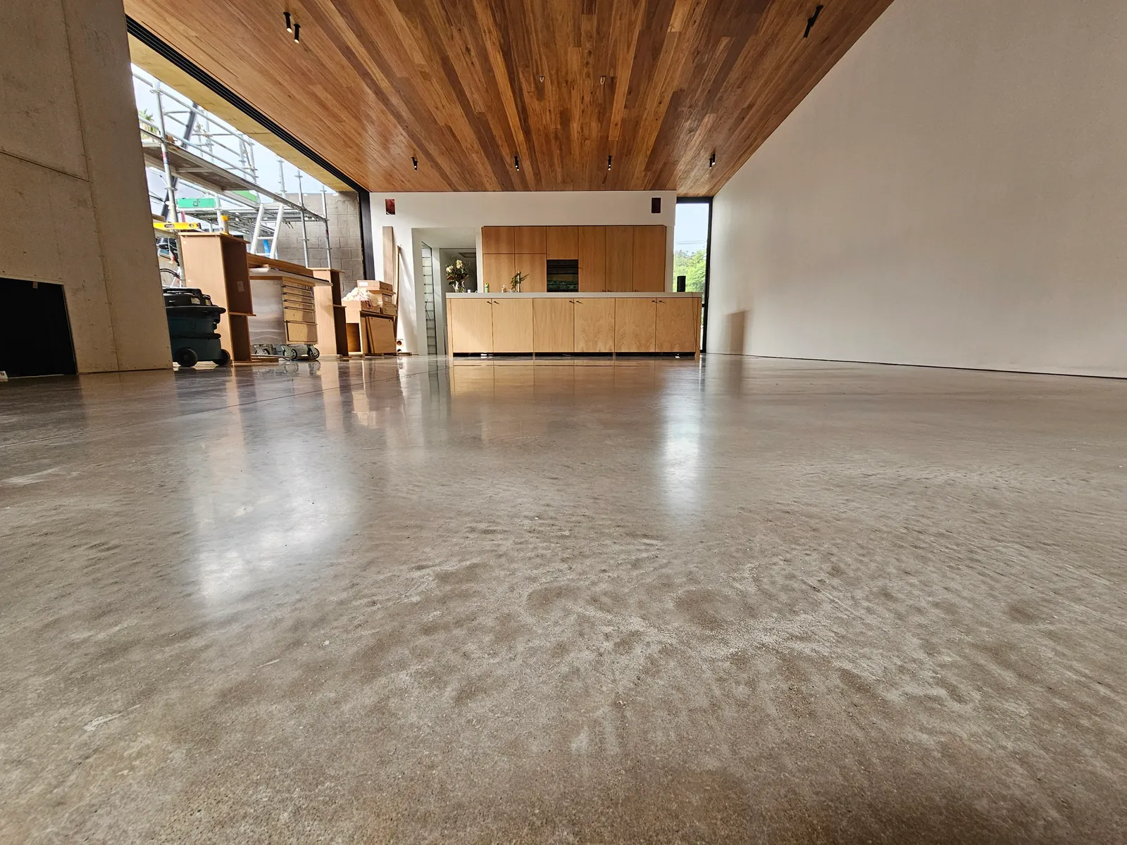 Diamond Shine Concrete polished concrete floor low-angle view in a modern Auckland living space with timber ceiling