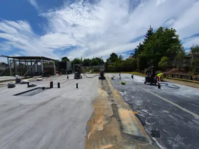 Diamond Shine Concrete prep grinding in progress on a large outdoor concrete slab in Auckland with industrial grinding equipment
