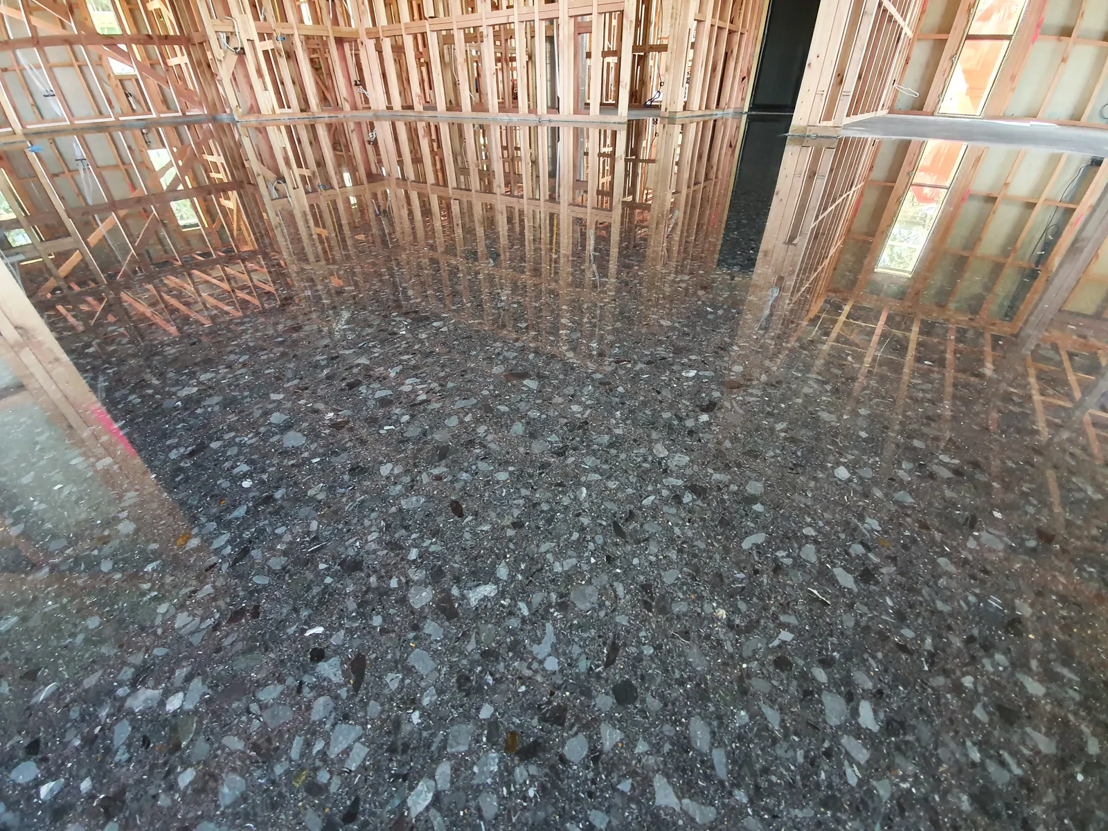 Diamond Shine Concrete dark black coloured polished concrete floor with exposed aggregate in Auckland new build construction