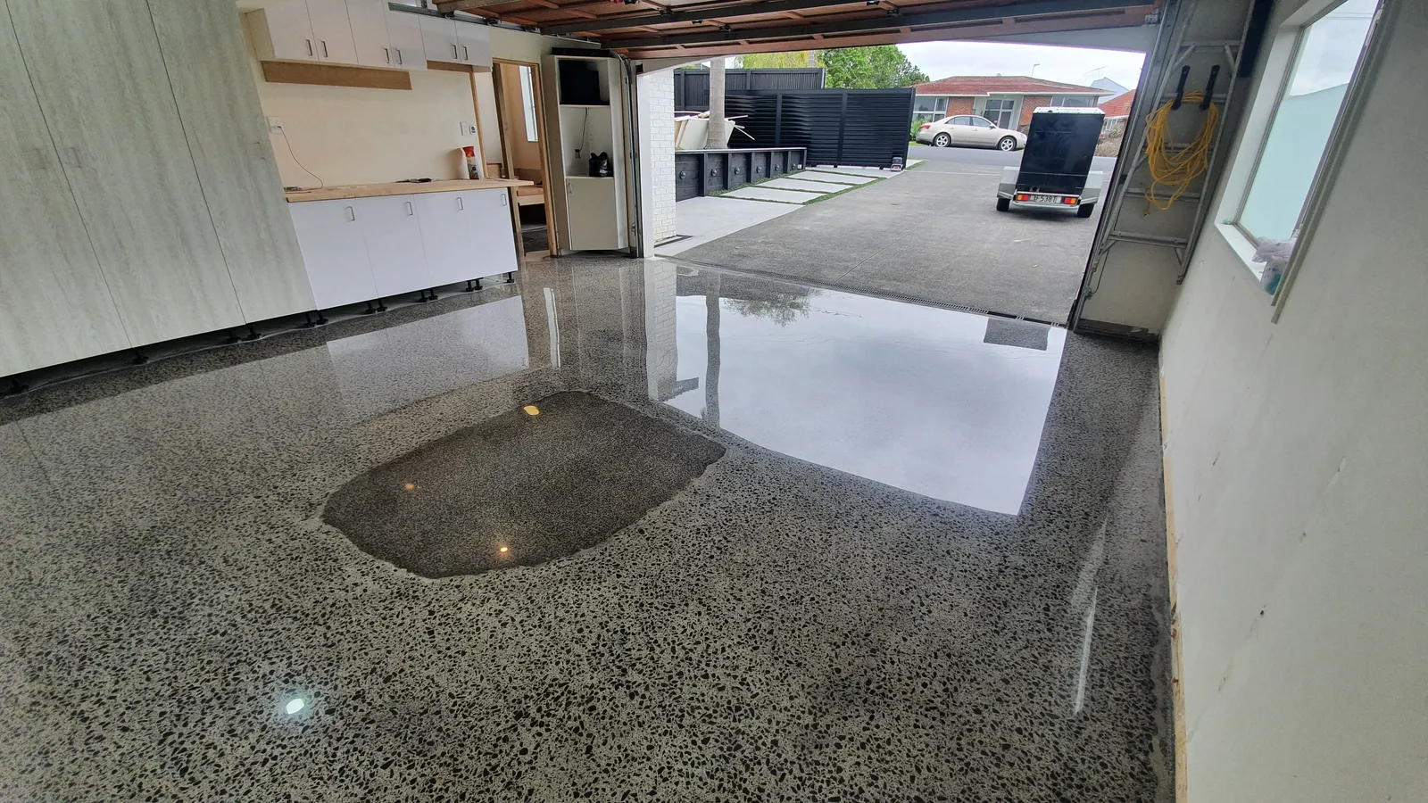 Diamond Shine Concrete - concrete floor problem showing dark discolouration stain on polished garage floor in Auckland requiring repair