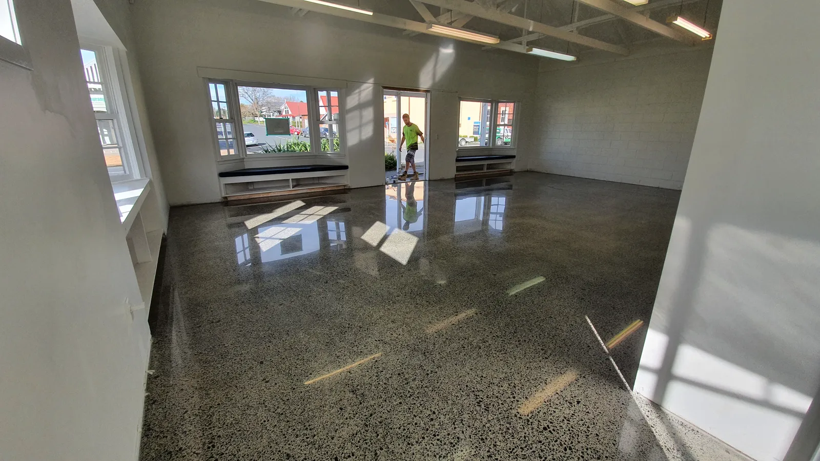 Diamond Shine Concrete mirror-finish polished concrete floor in large Auckland commercial space with exposed aggregate and natural light