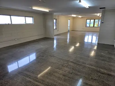 Diamond Shine Concrete polished pre-1990 concrete floor in an Auckland commercial space with natural aggregate banding and block walls