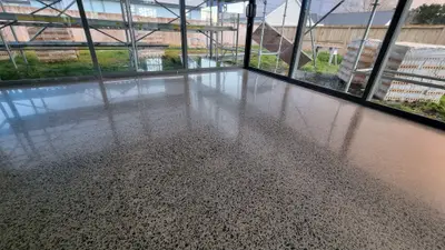 Diamond Shine Concrete satin polished concrete floor with exposed aggregate in Auckland residential room with floor-to-ceiling windows