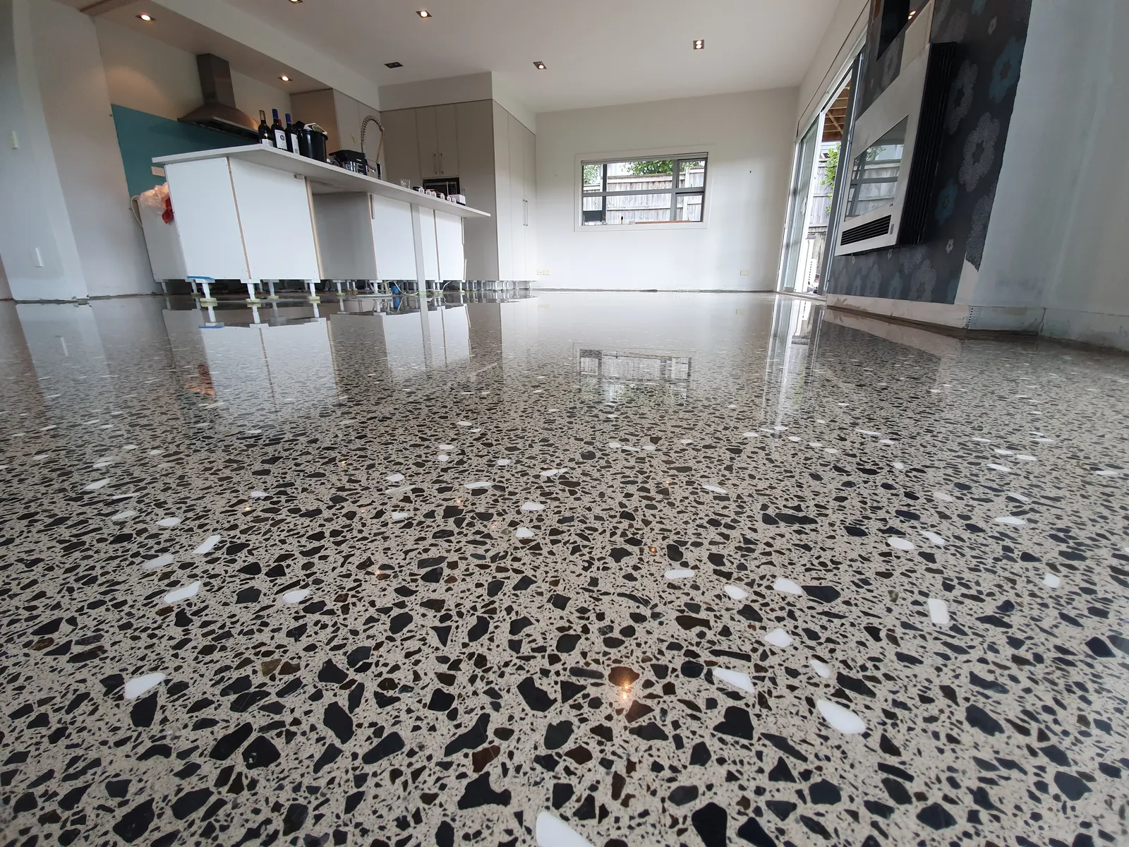 Diamond Shine Concrete polished concrete kitchen floor with full aggregate exposure in a modern Auckland home
