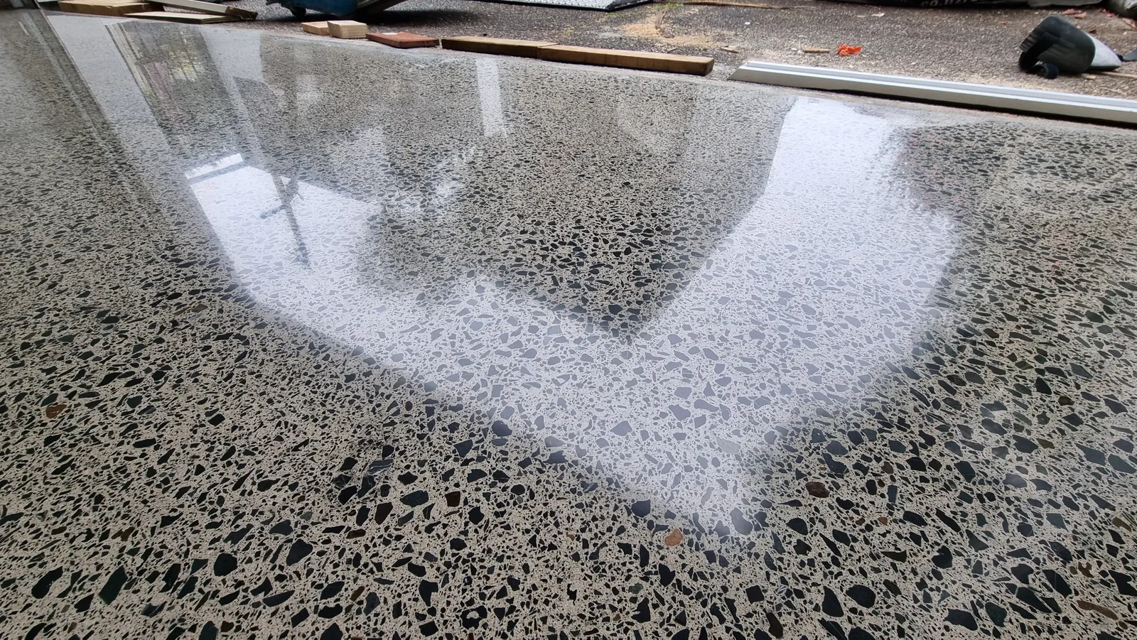 Diamond Shine Concrete high-gloss polished concrete floor detail showing mirror-like reflection and medium aggregate exposure in Auckland
