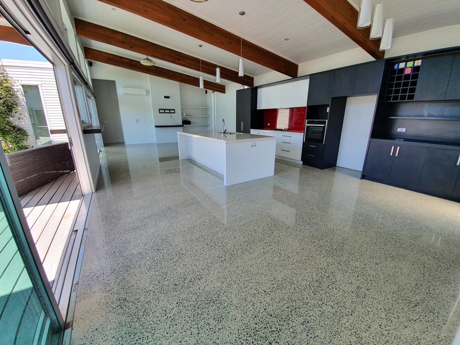 Diamond Shine Concrete polished concrete kitchen floor with exposed beams in Auckland home renovation